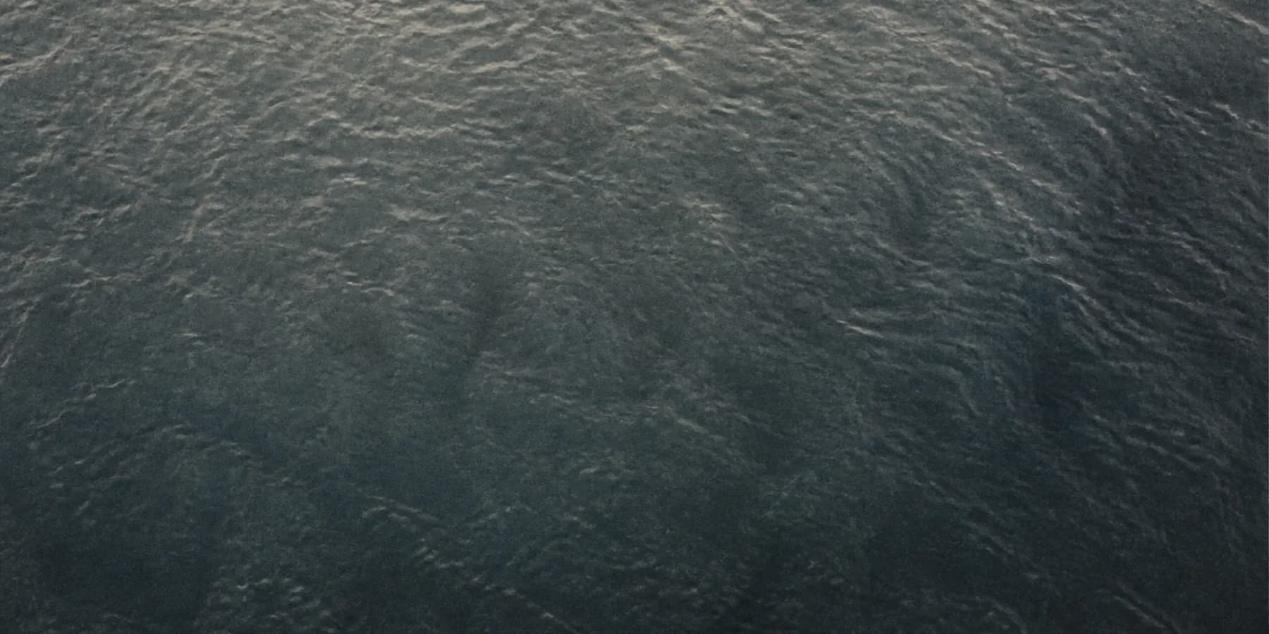 Looking straight down into clear dark water with a visible depth gradient
